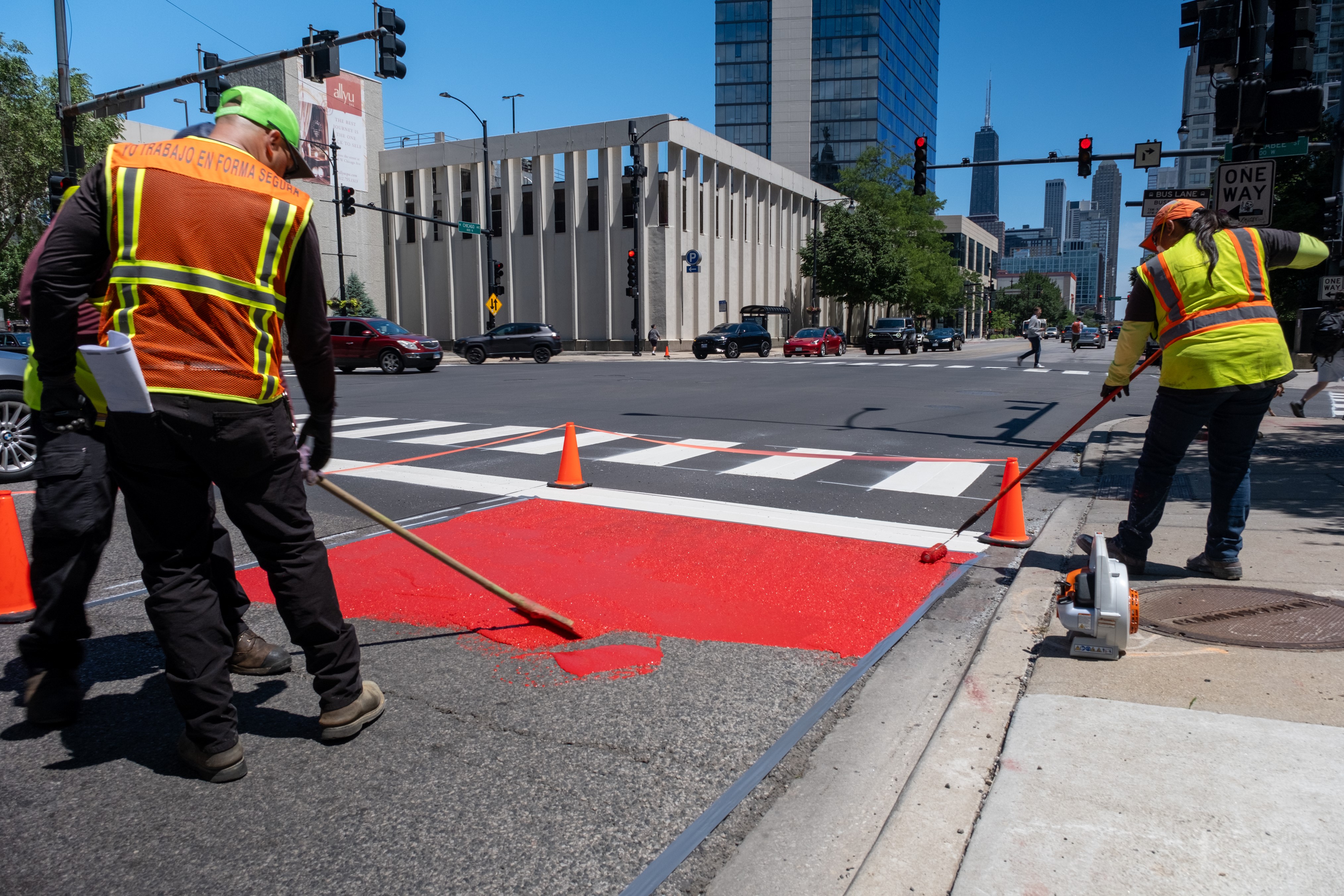 Crews installing red bus only pain on Chicago Ave